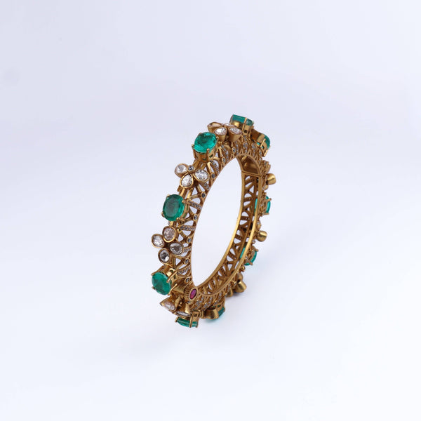 Angled view of a 22K gold-plated fashion bangle (single) highlighting its elegant structure, unique design, and polished gold finish
