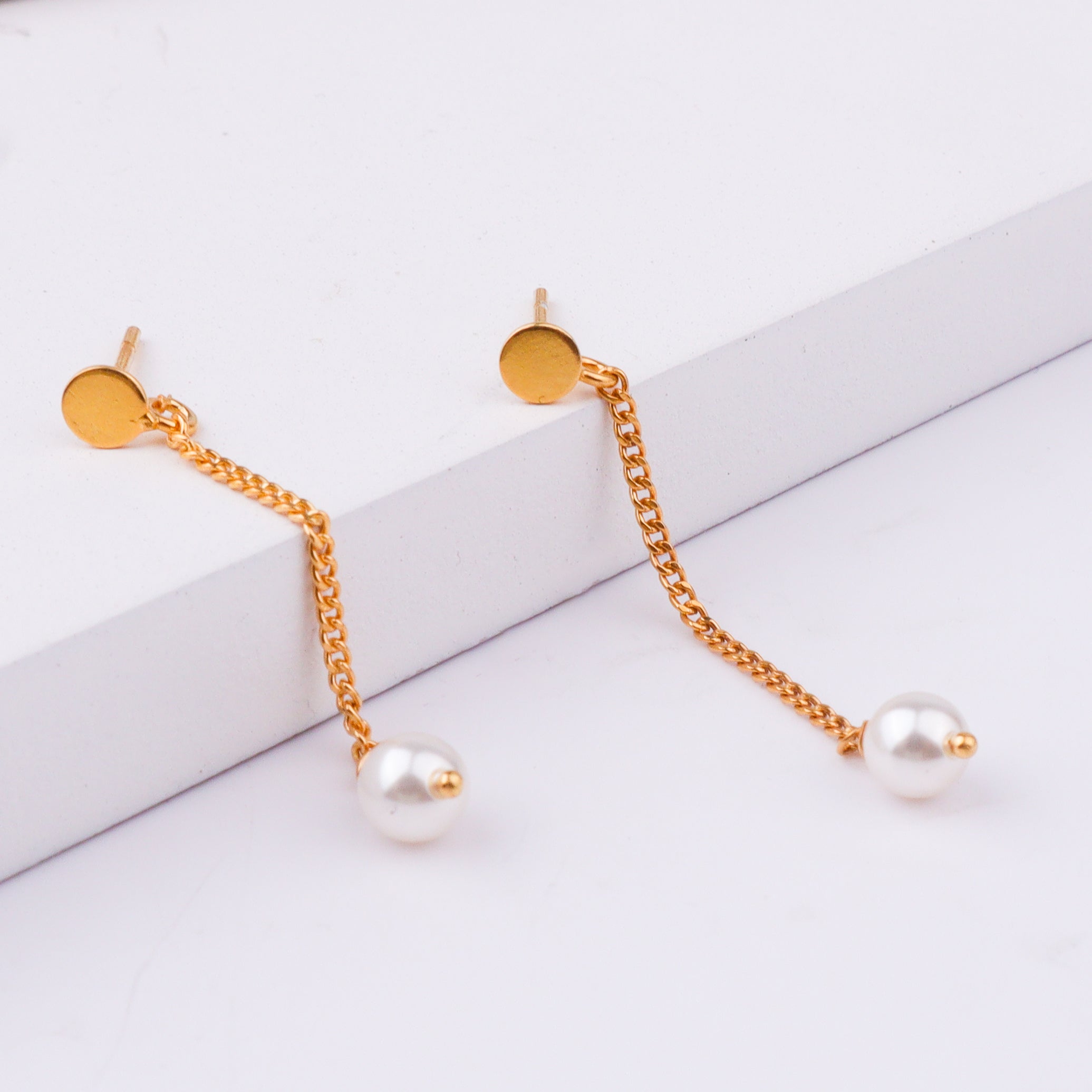 Back view of gold chain earrings with pearl drops