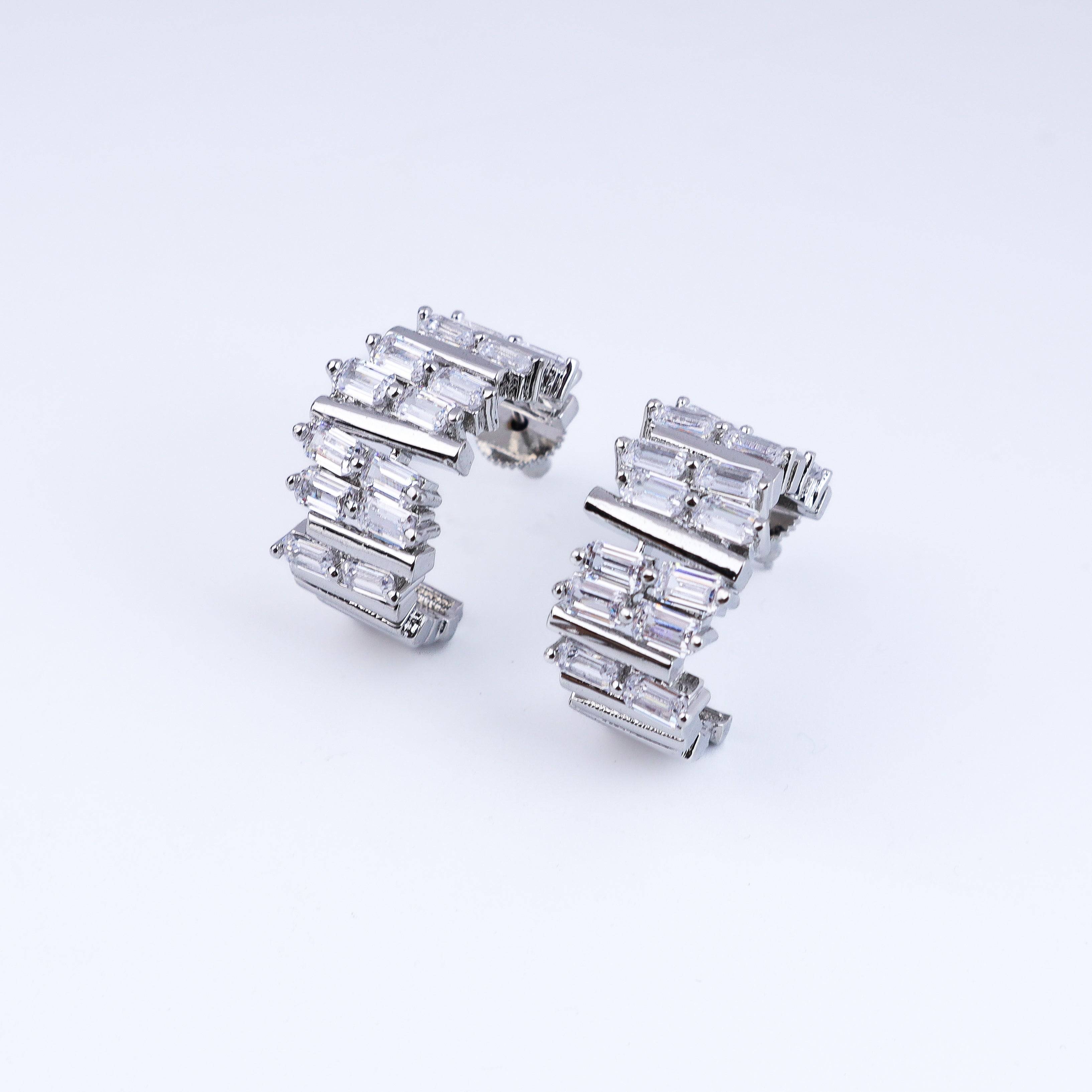 Angled view of the fashion earring highlighting its unique silhouette, structure, and polished finish