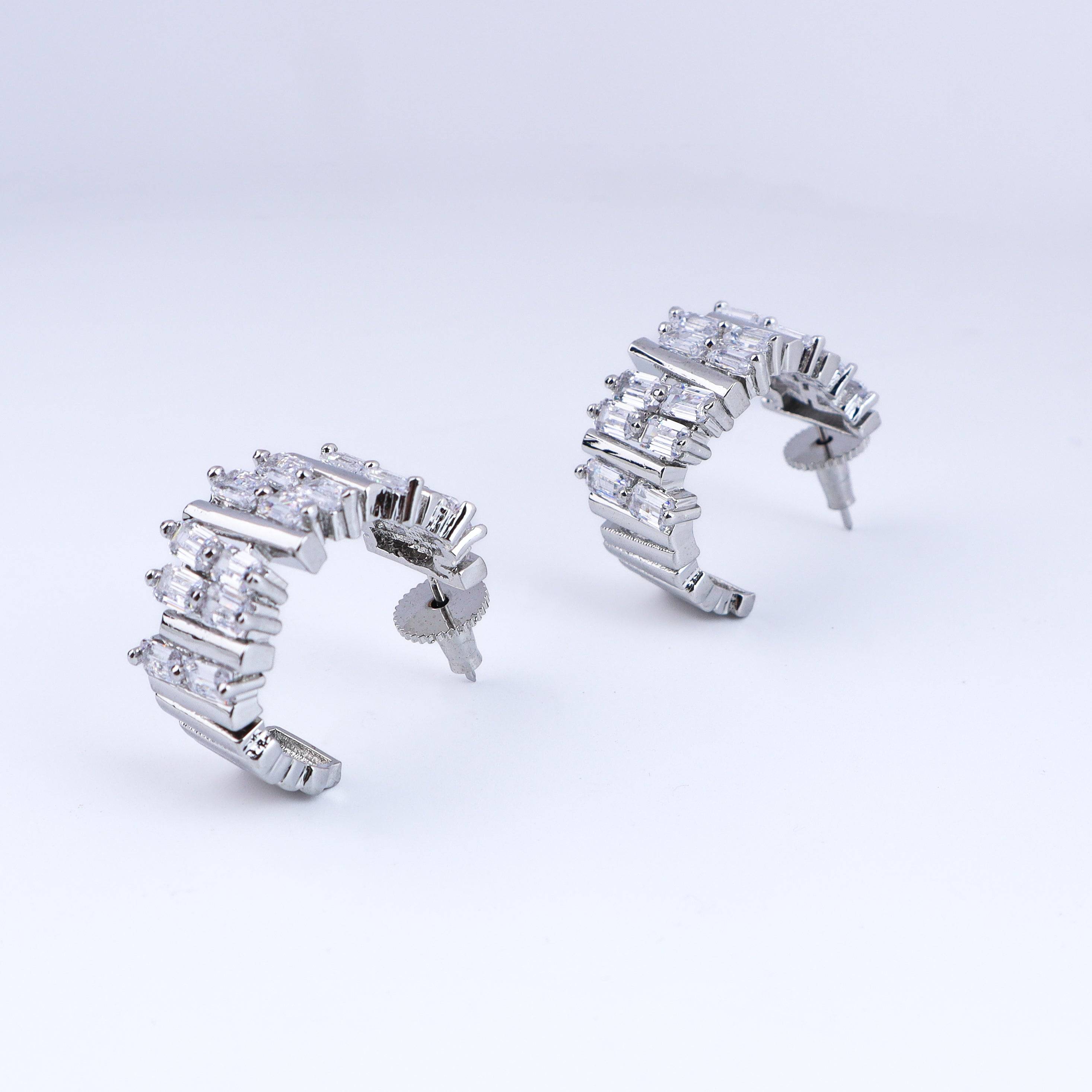 Detailed view of fashion earrings highlighting intricate motifs, textured detailing, and smooth jewelry finish