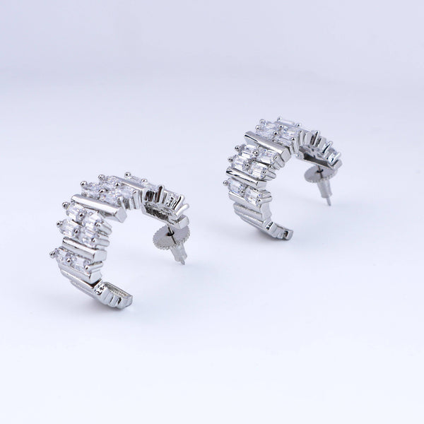 Detailed view of fashion earrings highlighting intricate motifs, textured detailing, and smooth jewelry finish