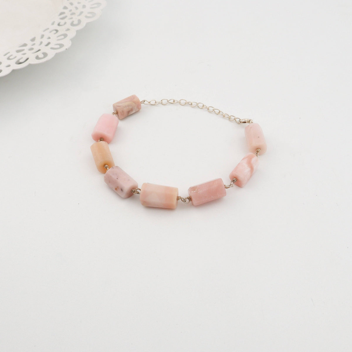 Woman styling Silver Pink Opal Ganthan Bracelet with festive wear