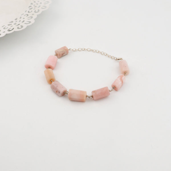 Woman styling Silver Pink Opal Ganthan Bracelet with festive wear
