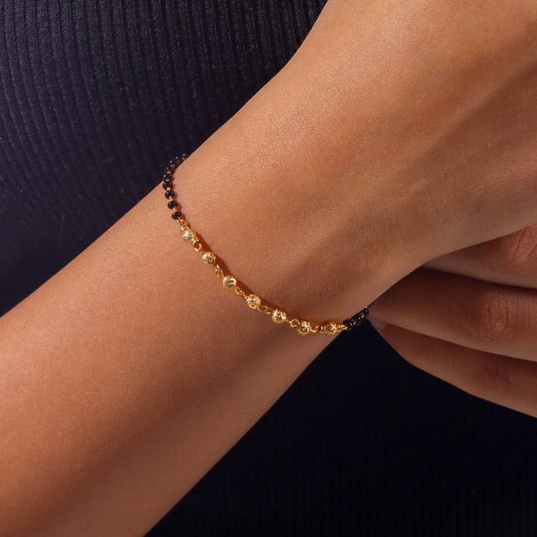 Model wearing 22K gold-plated fashion mangalsutra bracelet for an elegant and contemporary traditional jewellery look
