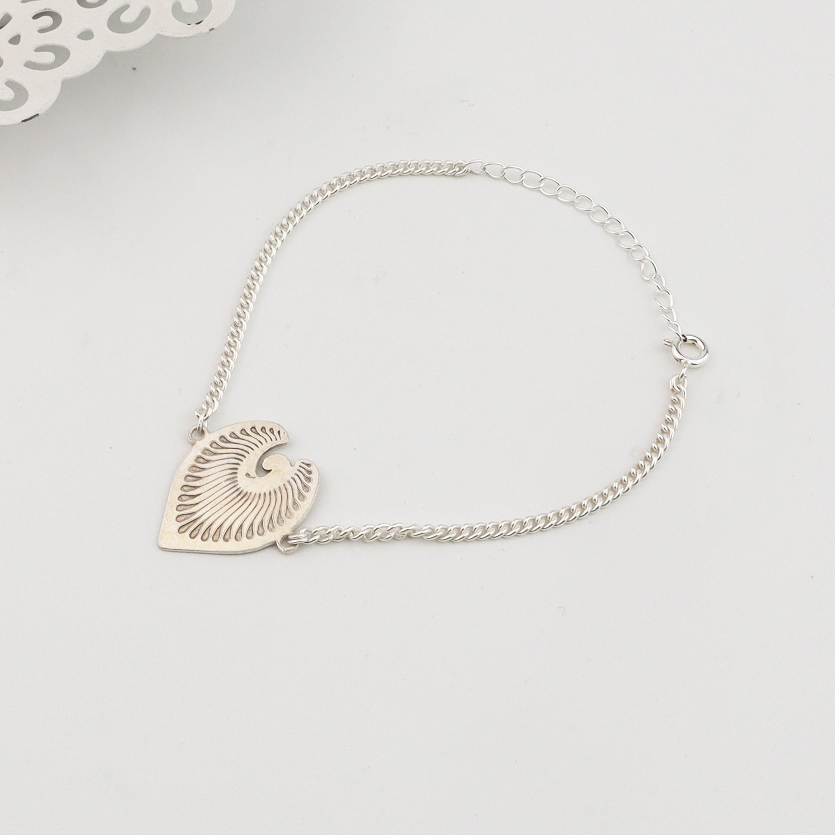 Angled side view of Silver Peacock Feather Bracelet