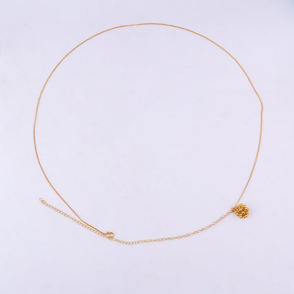 Gold chain with floral pendant on white background