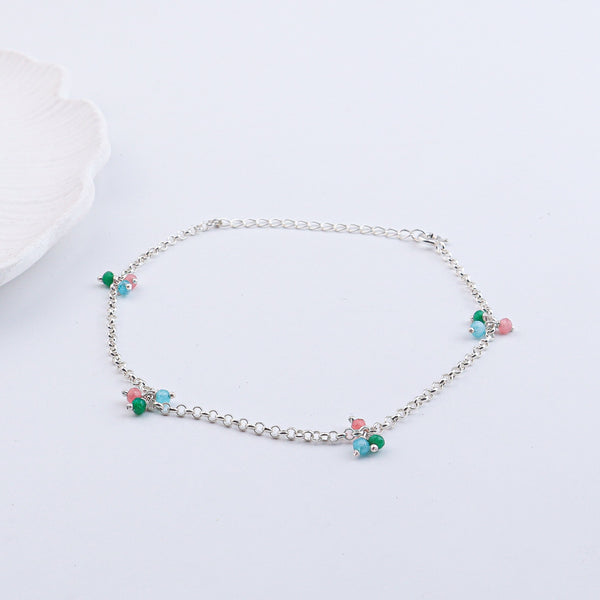 Silver anklet with colorful beads on a white background