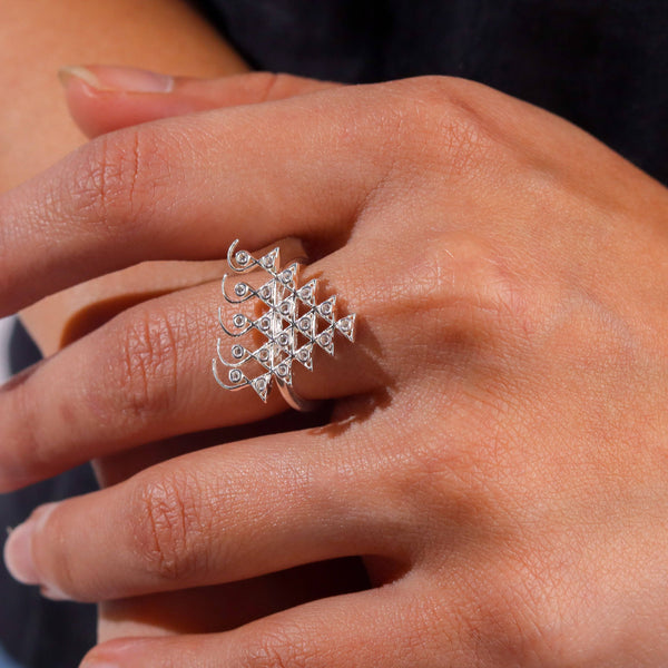 Silver Saraswati ring with cubic zirconia on finger