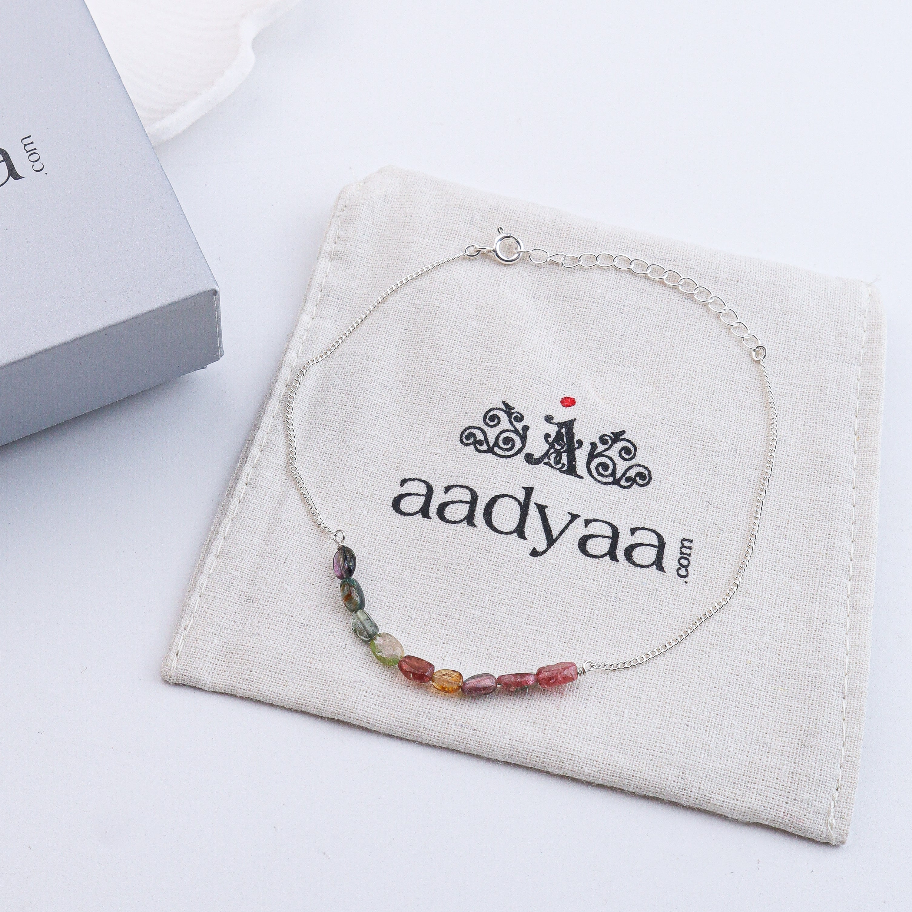 Rainbow gemstone anklet on wrist