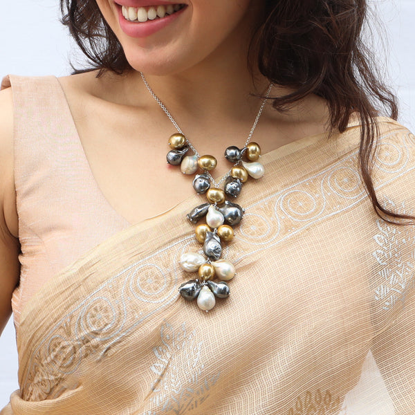 Woman wearing silver chain necklace with multicolored baroque pearls