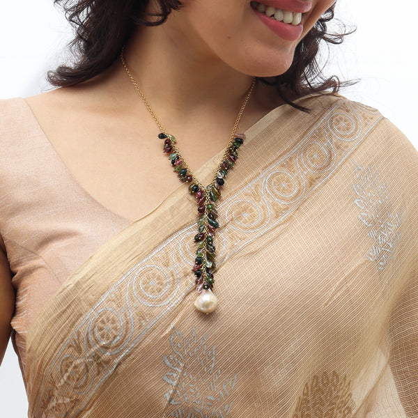 Woman wearing multicolor tourmaline and pearl necklace