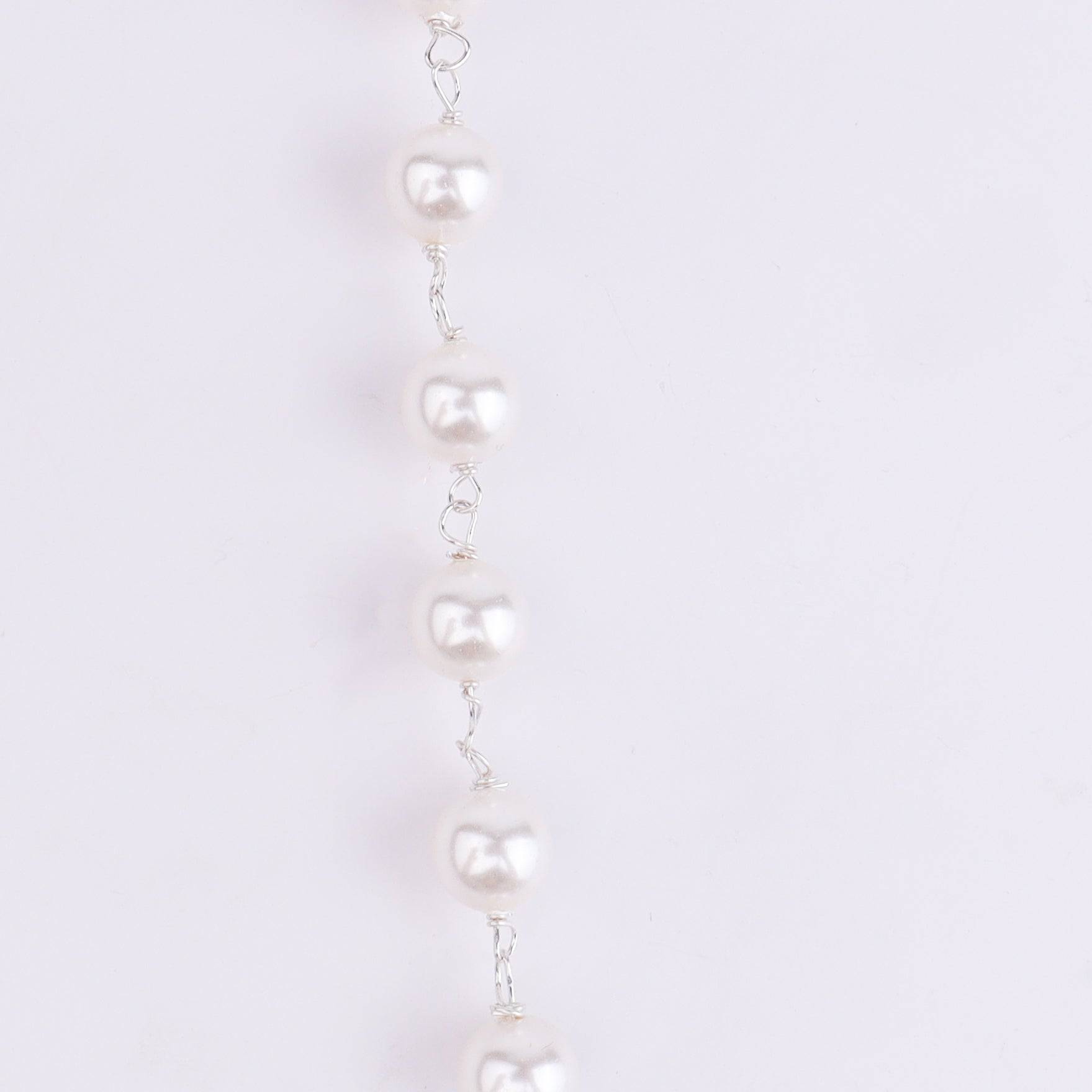 Angled view of Silver Pink & White CZ Tanmani Set with Pearl Ganthan featuring a detailed 92.5 sterling silver design