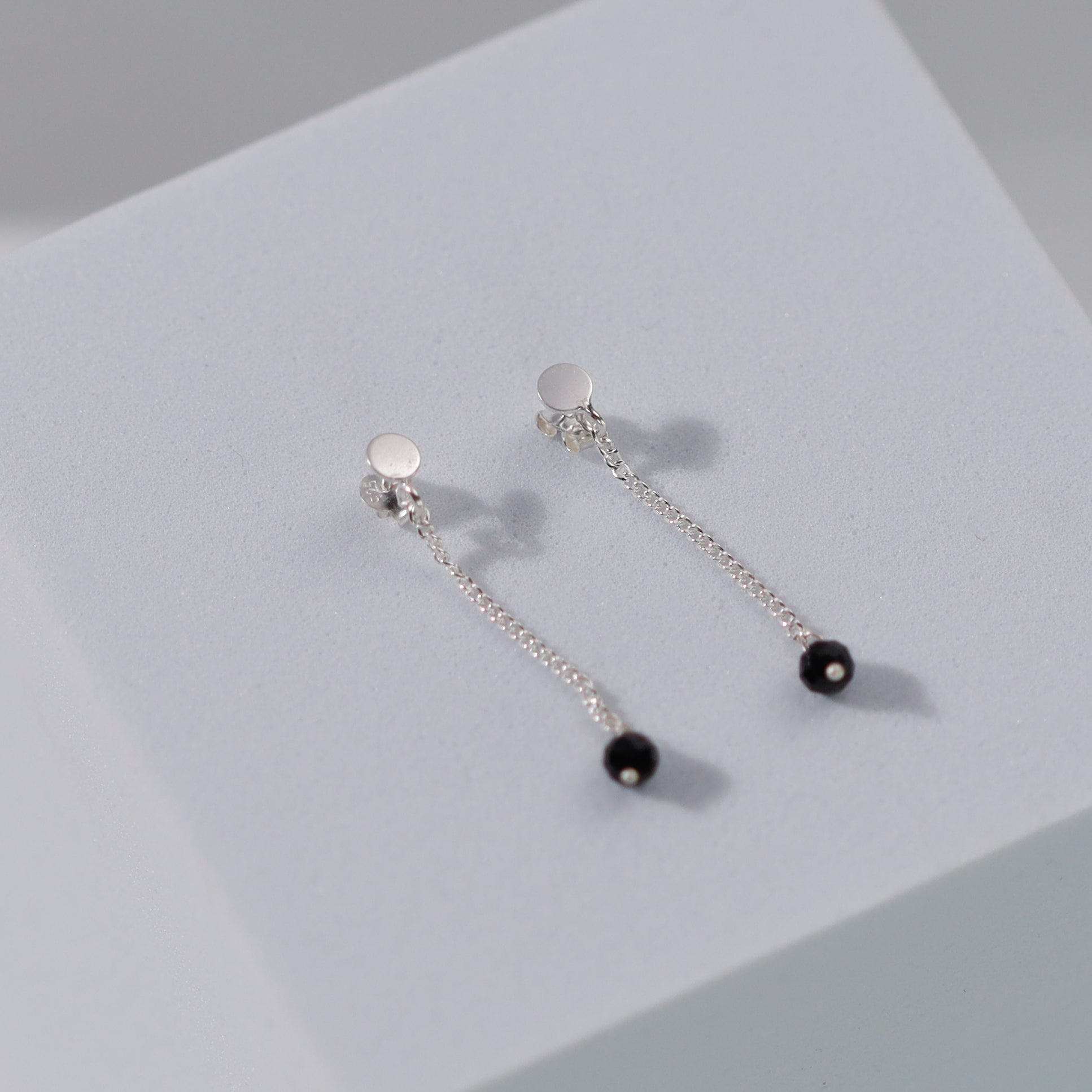 Minimal black spinel chain earring design