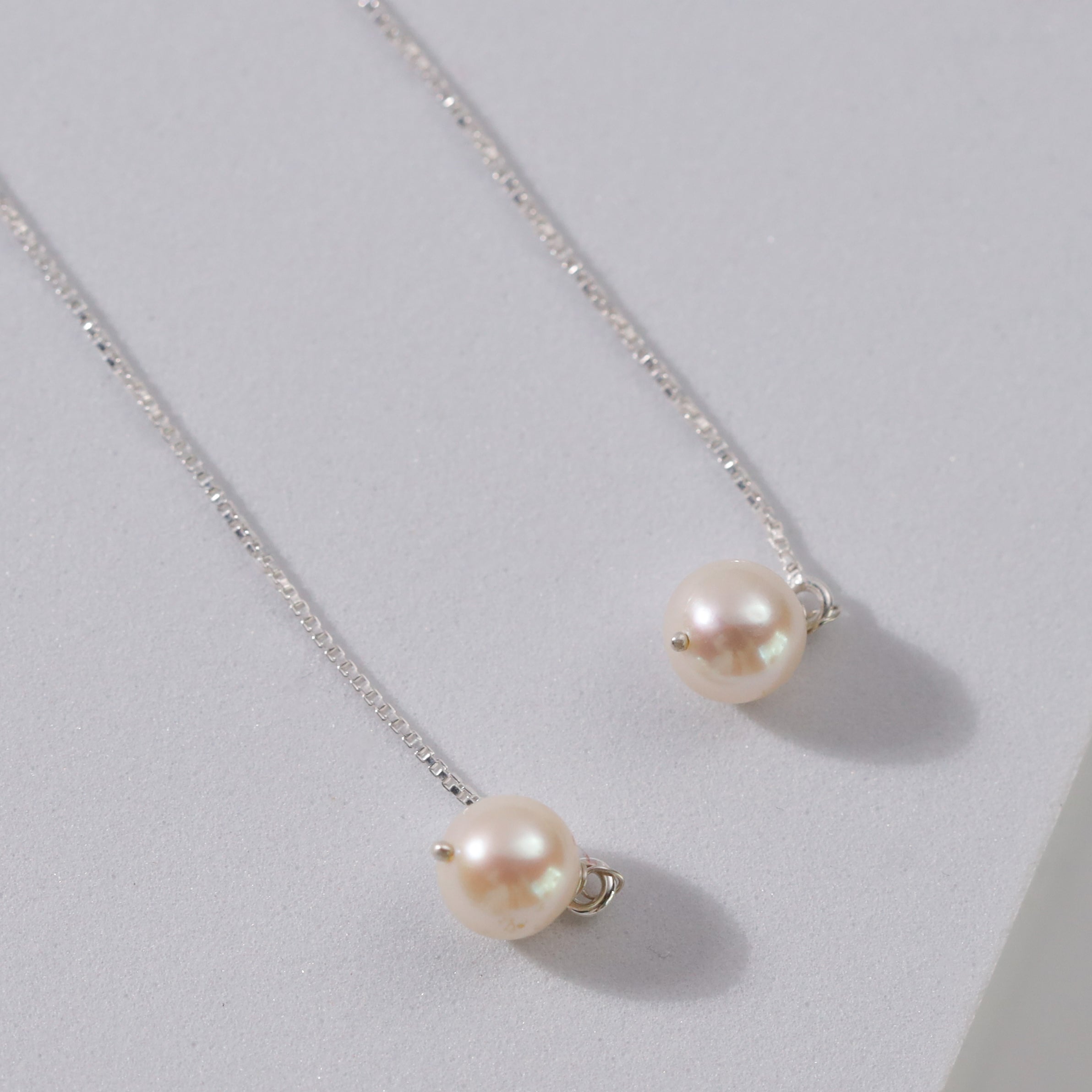 Minimal pearl threader earrings design