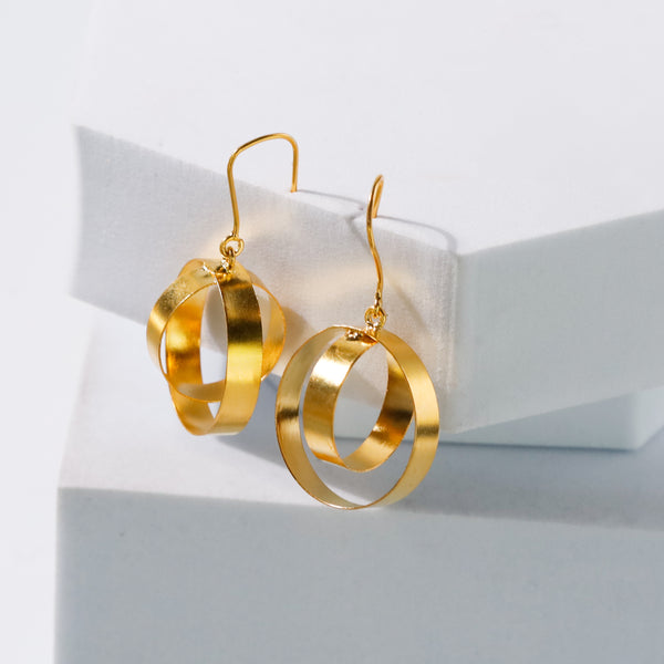 Woman wearing gold earrings with styled hair
