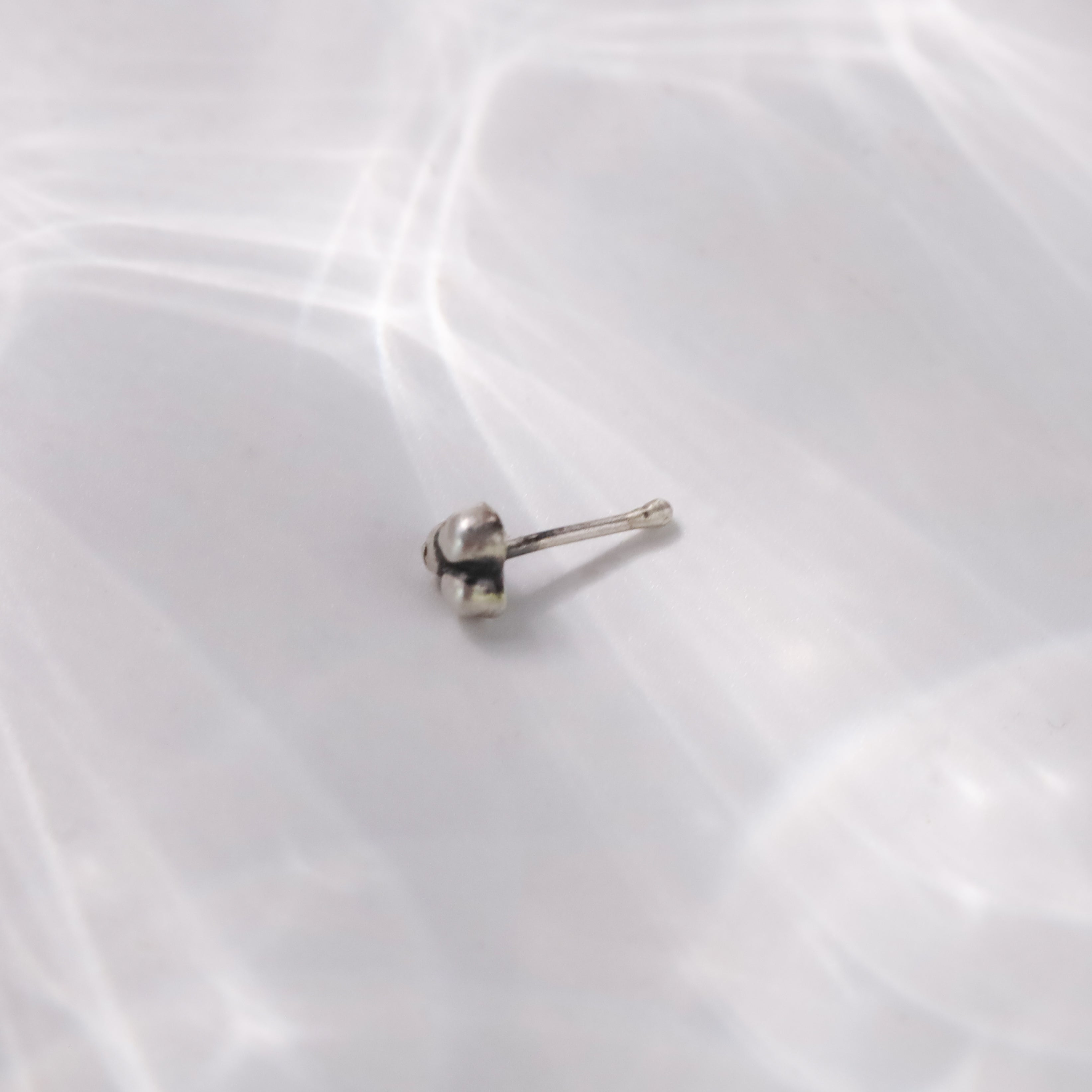 Tiny silver nose pin design