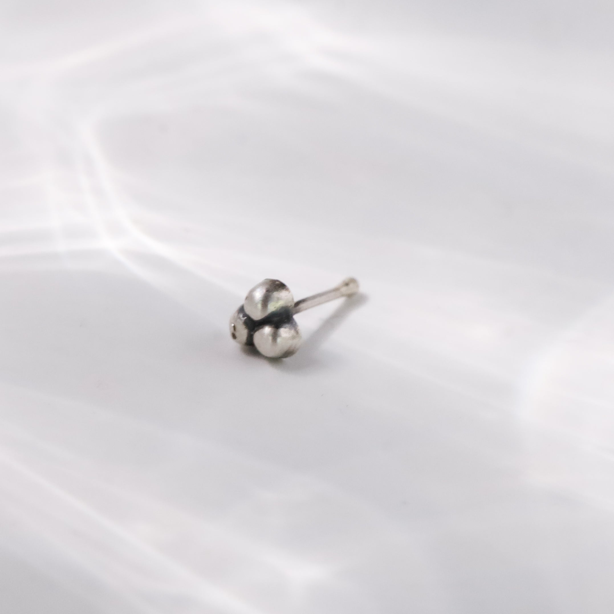 Flat lay of Silver Dainty Nose Pin on neutral background