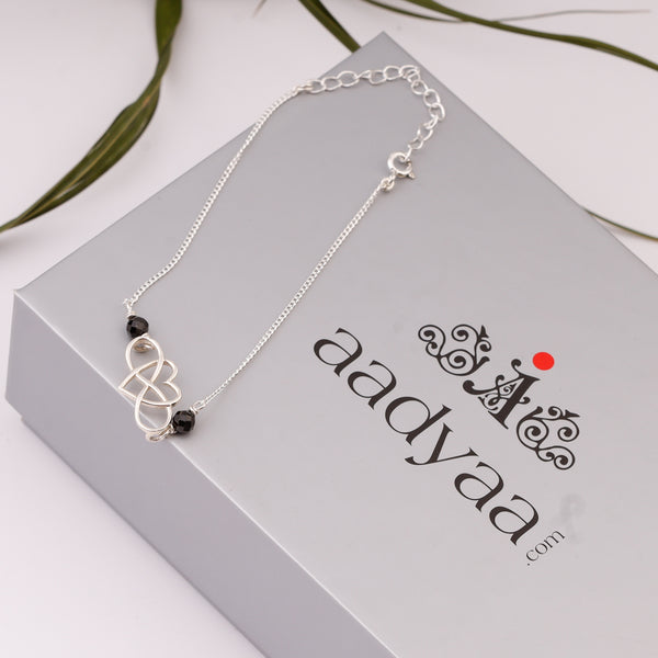 Silver chain mangalsutra bracelet with infinity and black beads