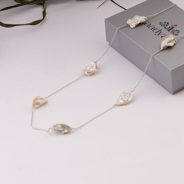 Pearl and silver chain jewelry on white background