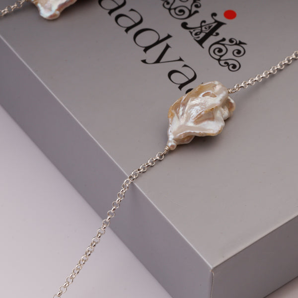 Pearl necklace with silver chain on display