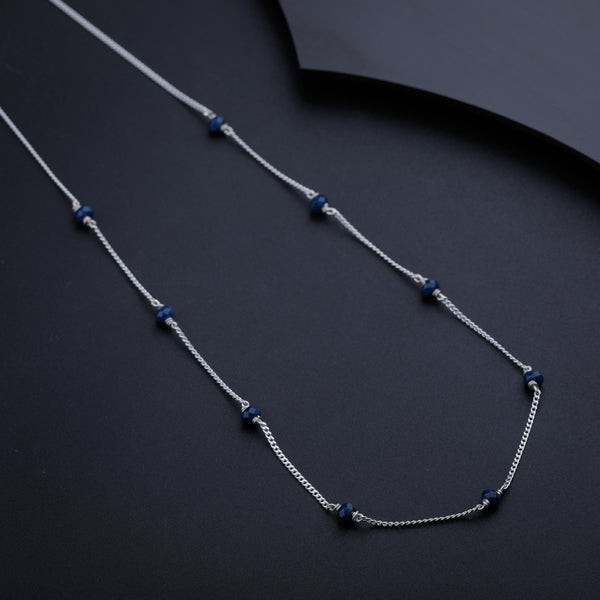 Close-up of navy blue beads on silver chain necklace
