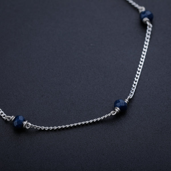 Navy Blue Sapphire Silver Chain necklace with faceted beads on dark background
