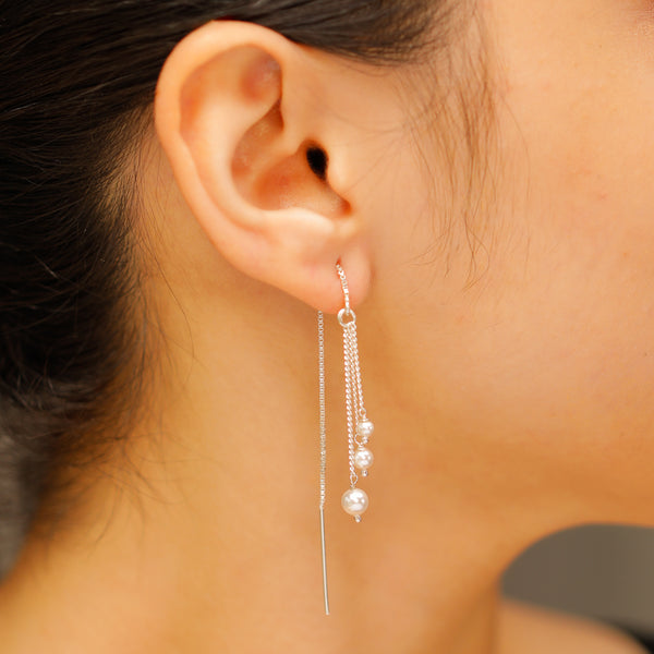 Three pearl drop silver threader earrings close-up handcrafted detailing