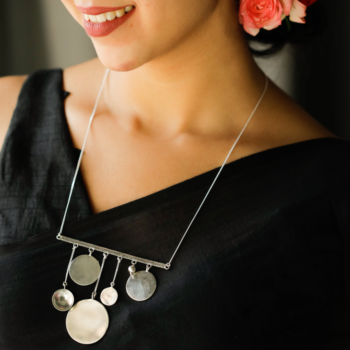 coin motif detailing on silver abstract necklace