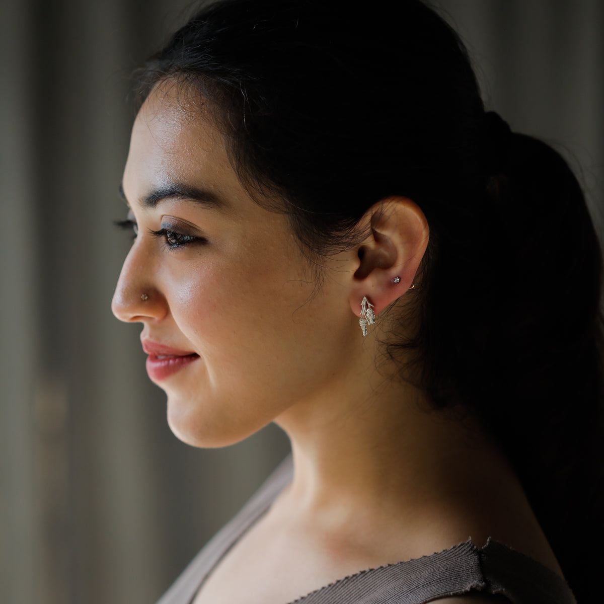 Silver earrings on woman