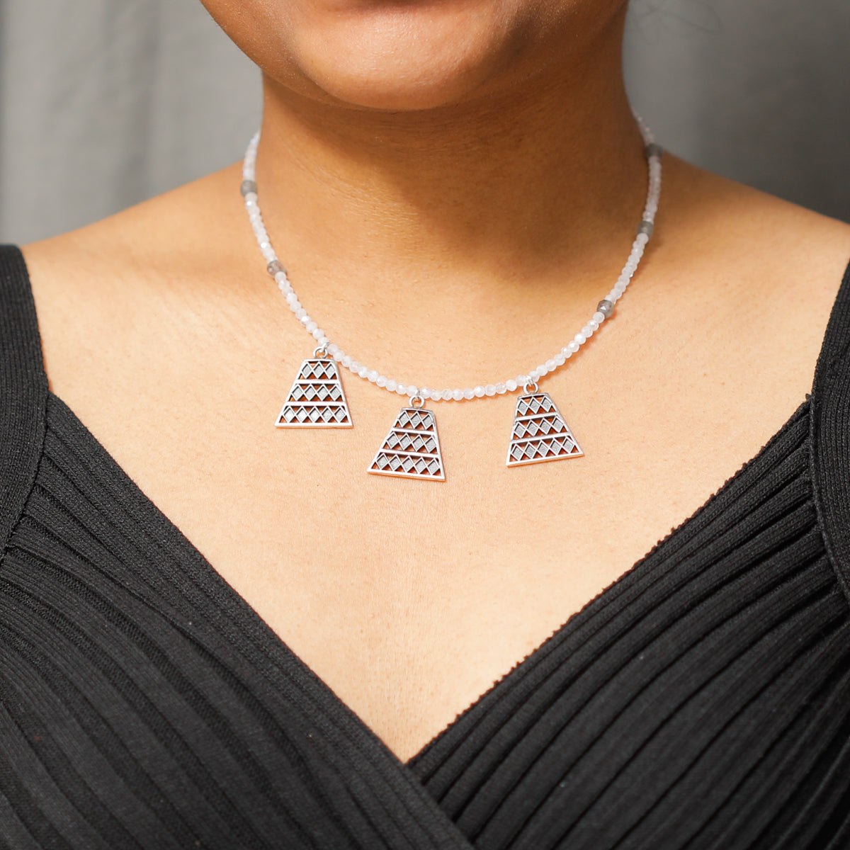 Model wearing silver trapezoid pendant necklace with moonstone