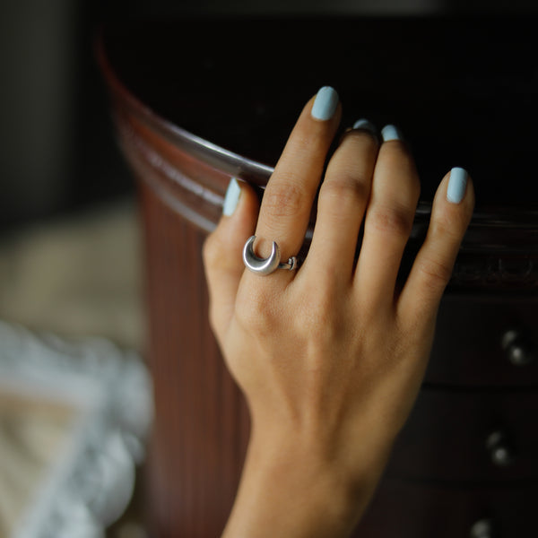 Silver Moon Ring on hand with light blue nails