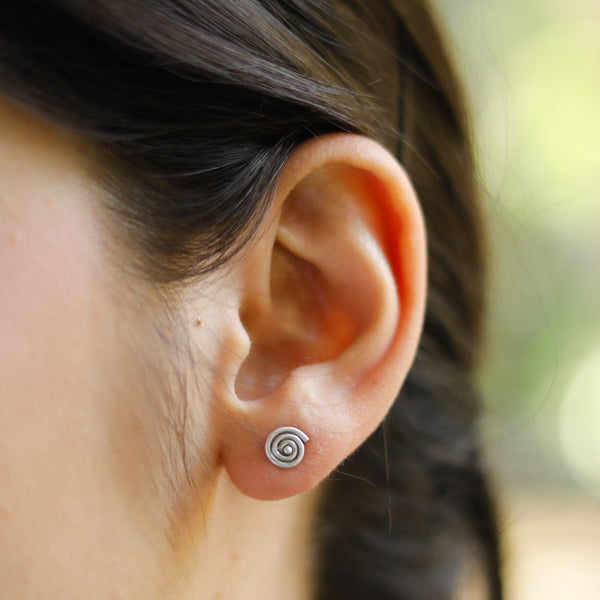 Sterling silver spiral stud earring on ear