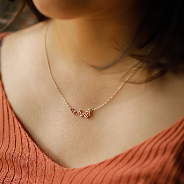 mother pendant detailing on silver necklace