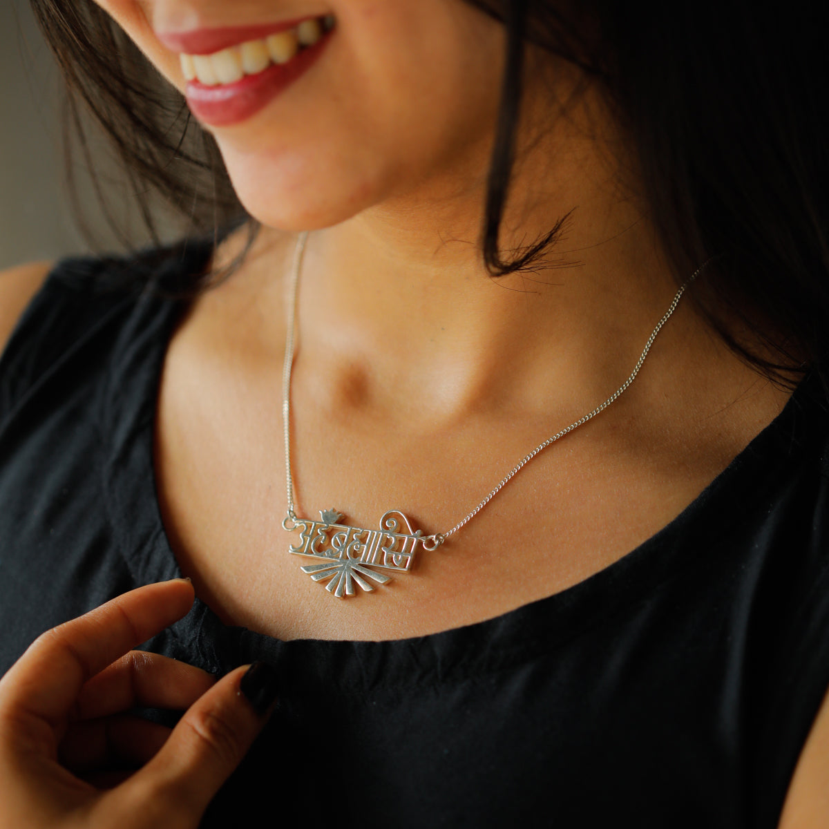 Ahambrahmasmi Sanskrit inscription laser cut on silver necklace