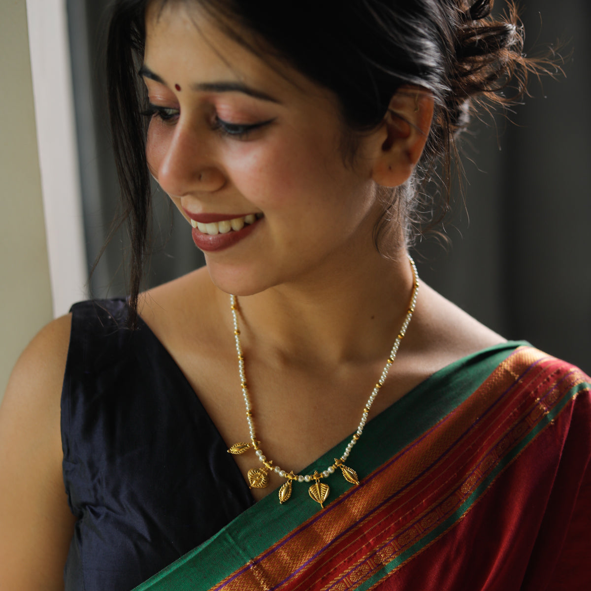 leaf and badam motif detailing on pearl necklace