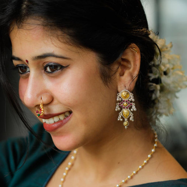 Elegant Rajasthani silver earrings with intricate design and gemstone accents