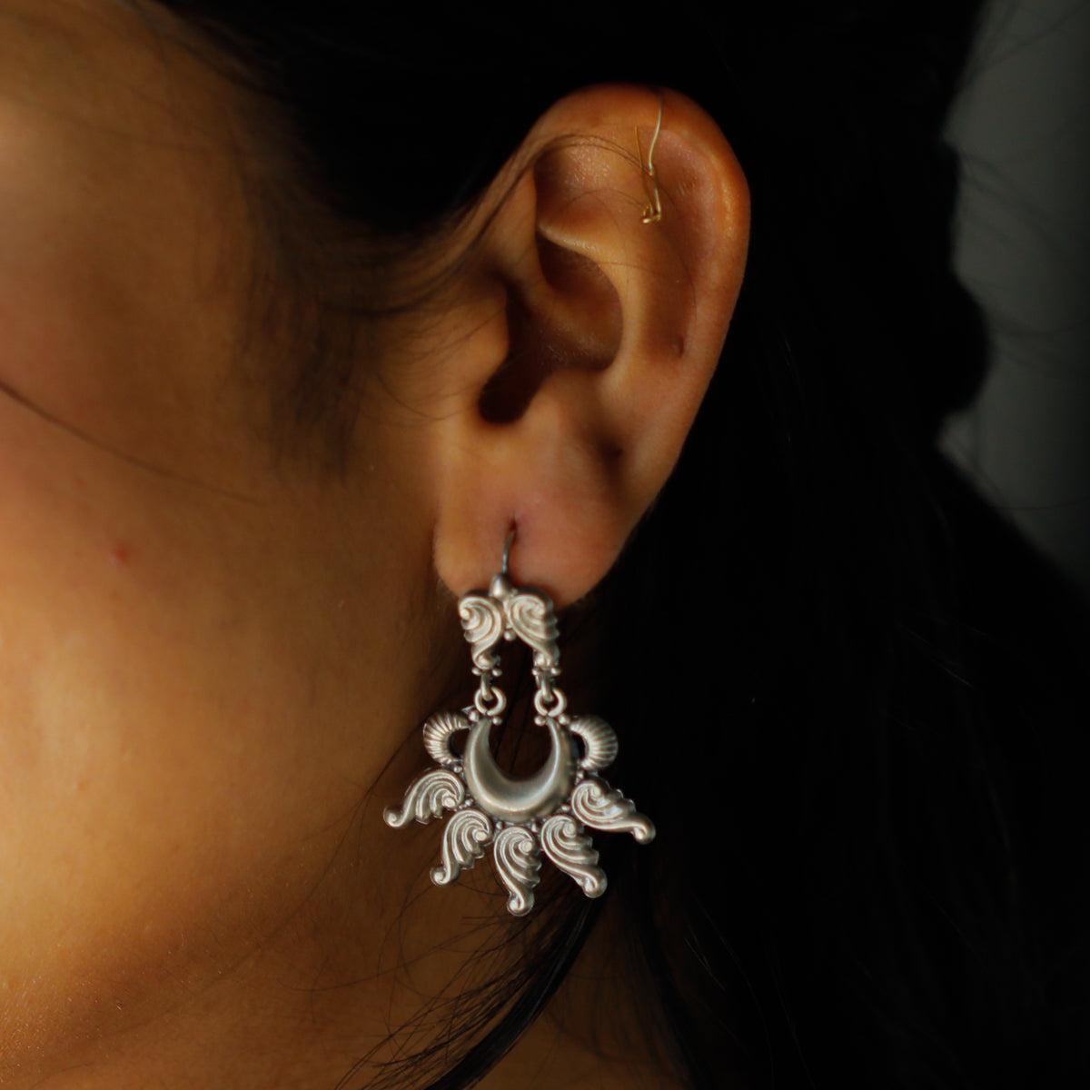 Moon and conch inspired silver shankha earrings close-up detailing