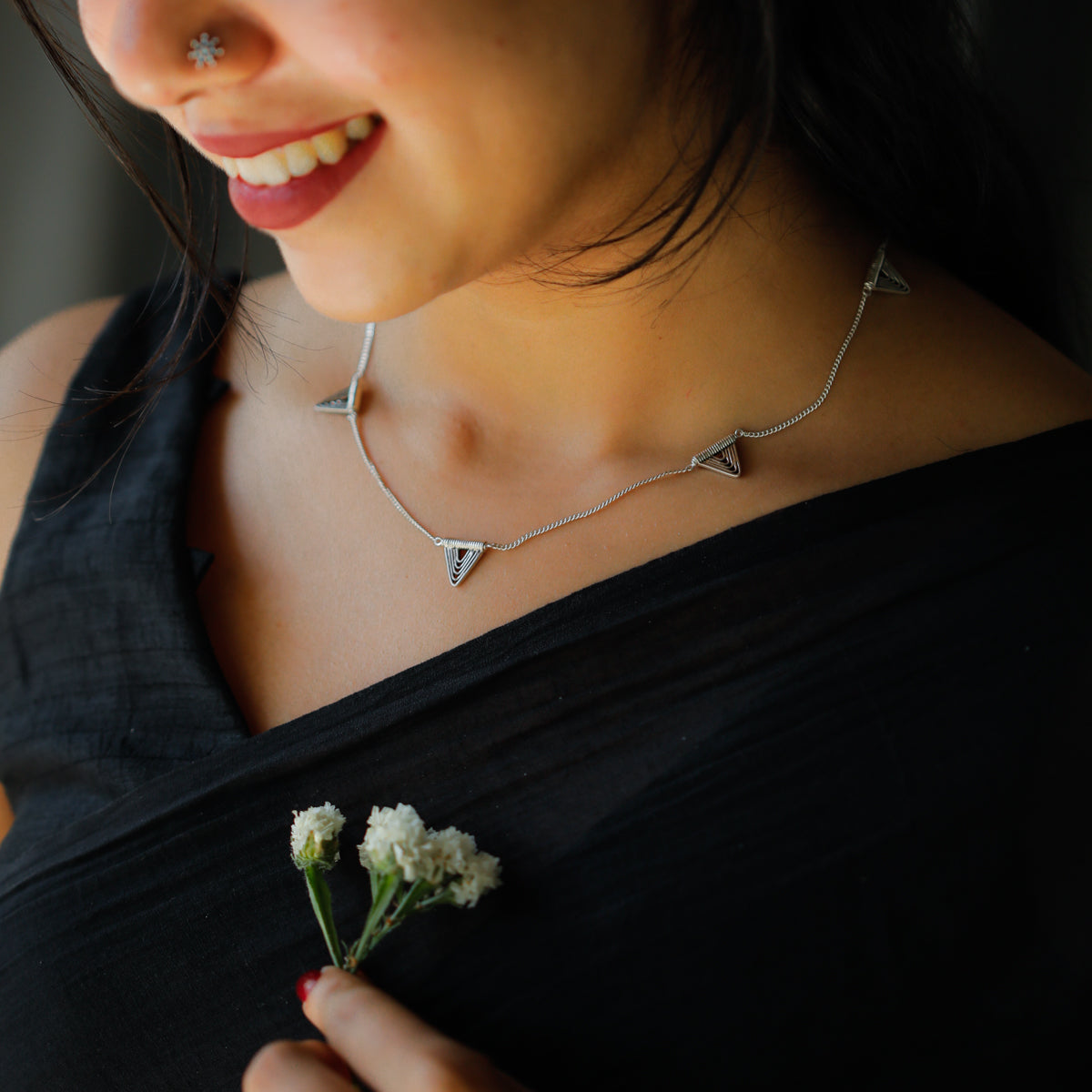 spiral triangle detailing on silver necklace