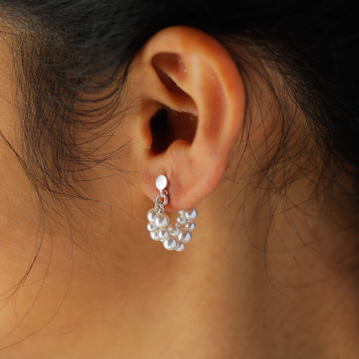Pearl earrings on ear