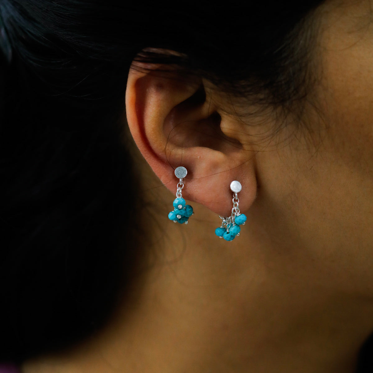 Turquoise silver trinket earrings close-up handcrafted detailing