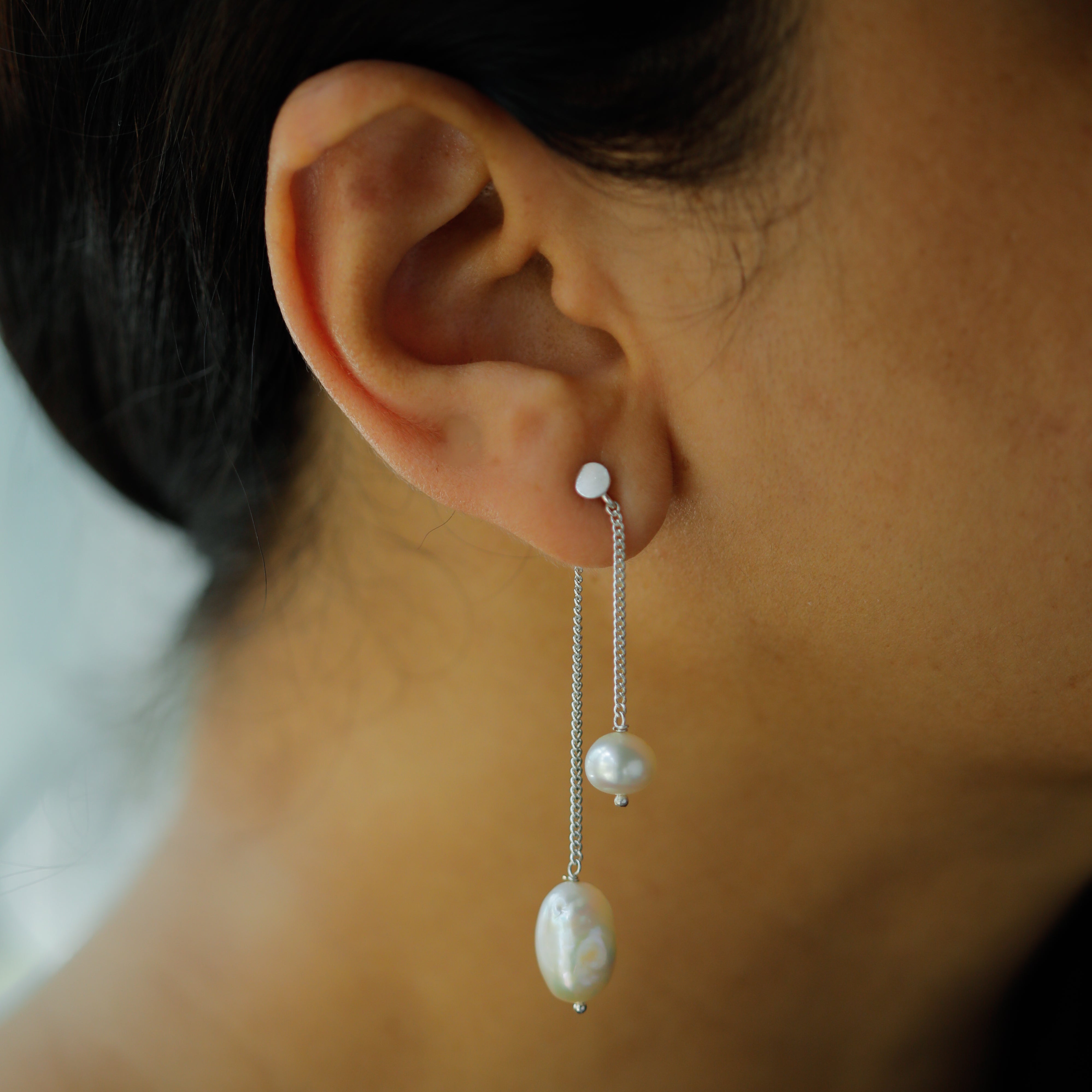 Elegant pearl drop earrings with cascading pearls on silver chain