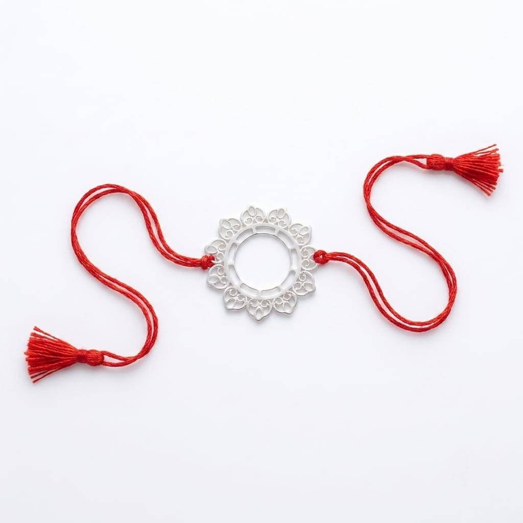 Flat-lay of Big Filigree Silver Rakhi with festive décor, gift box, and Raksha Bandhan essentials