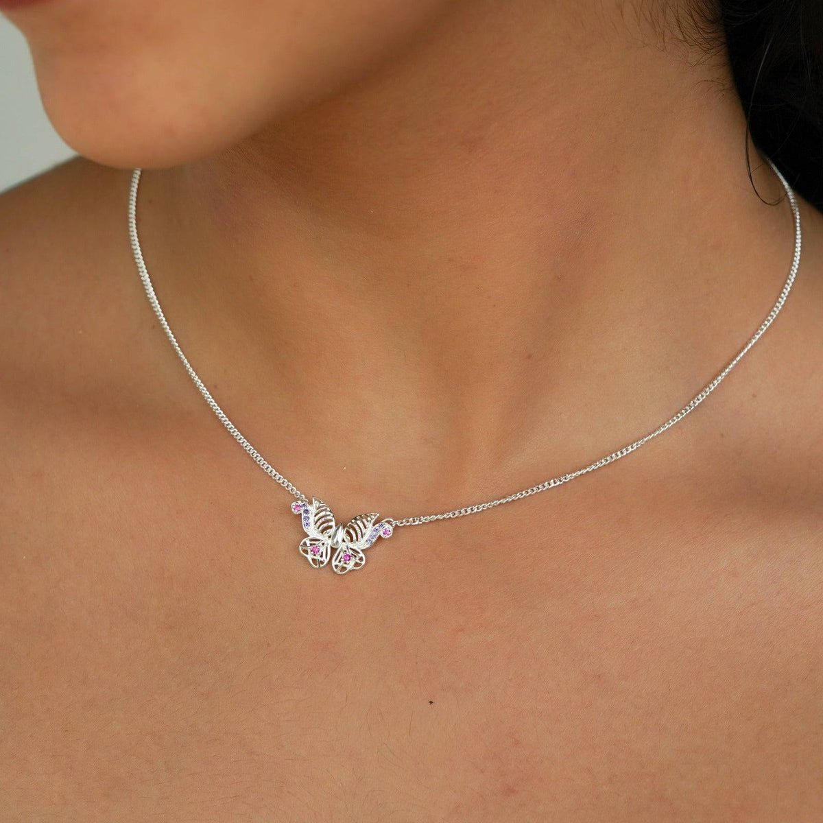 Silver butterfly charm necklace with pink and purple stones
