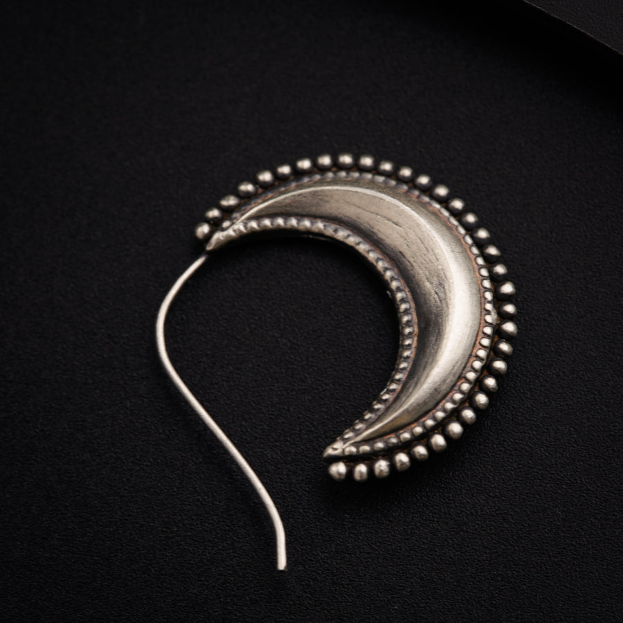 a close up of a metal object on a black surface