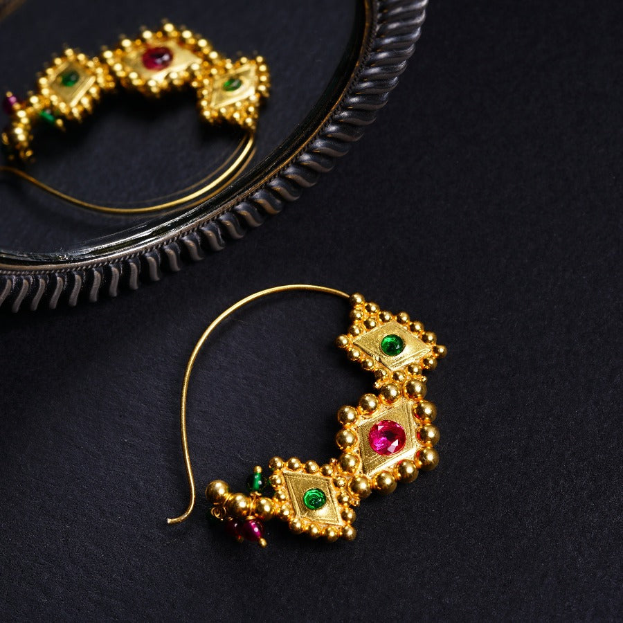 a pair of gold - plated earrings with colored stones