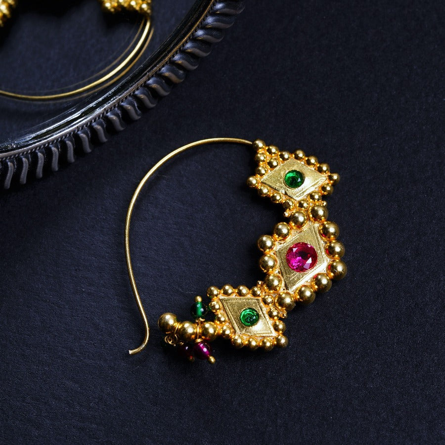 a close up of a pair of earrings on a table