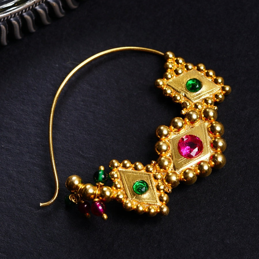 a close up of a pair of earrings on a table