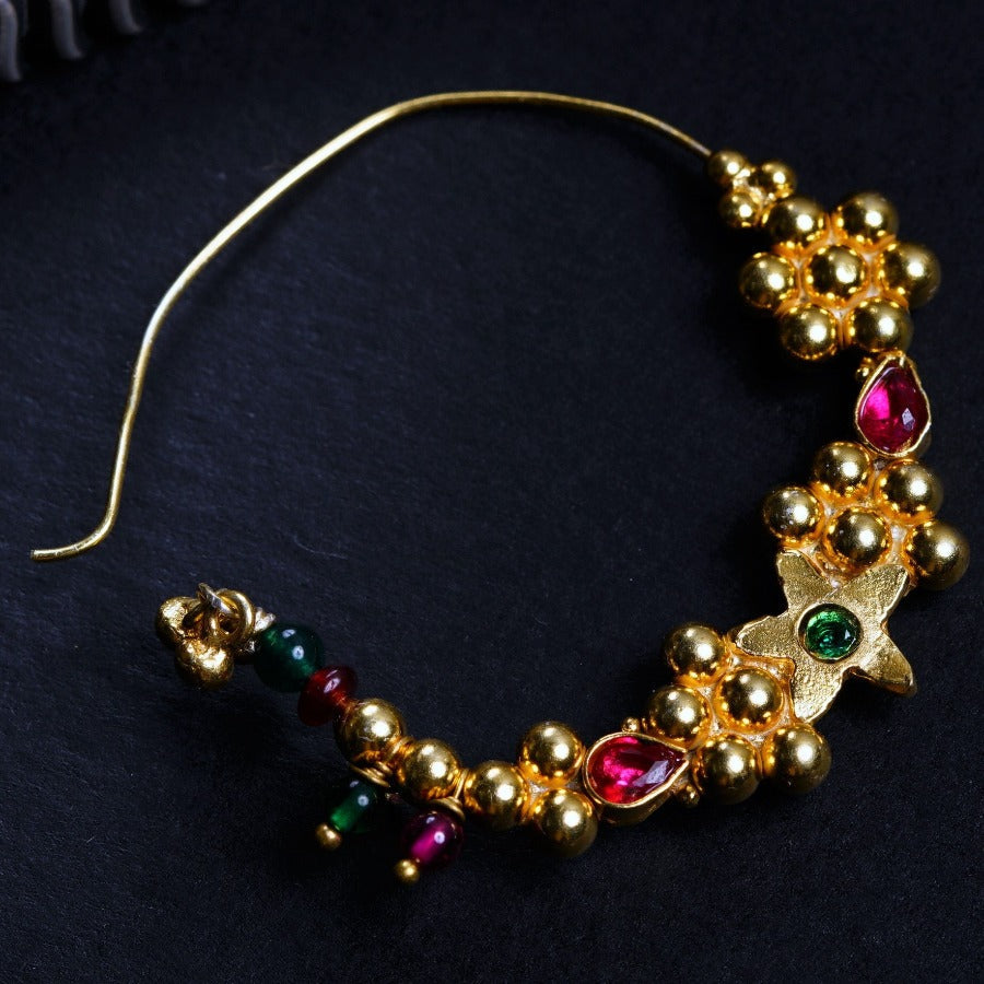 a close up of a bracelet on a black surface