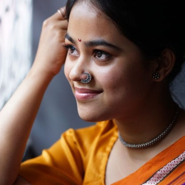 a woman with a nose ring and nose piercing