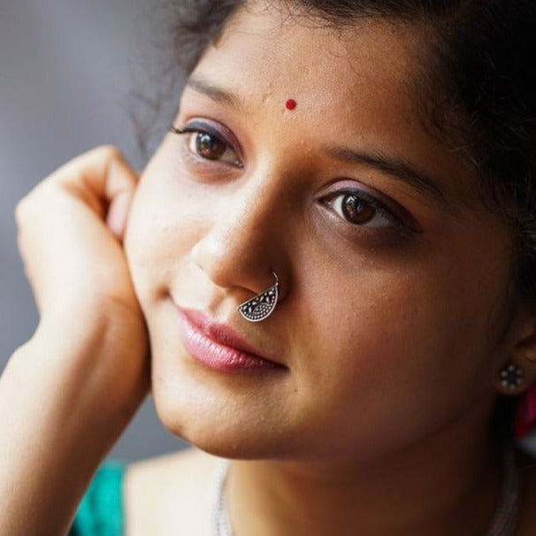 a close up of a woman with a nose ring